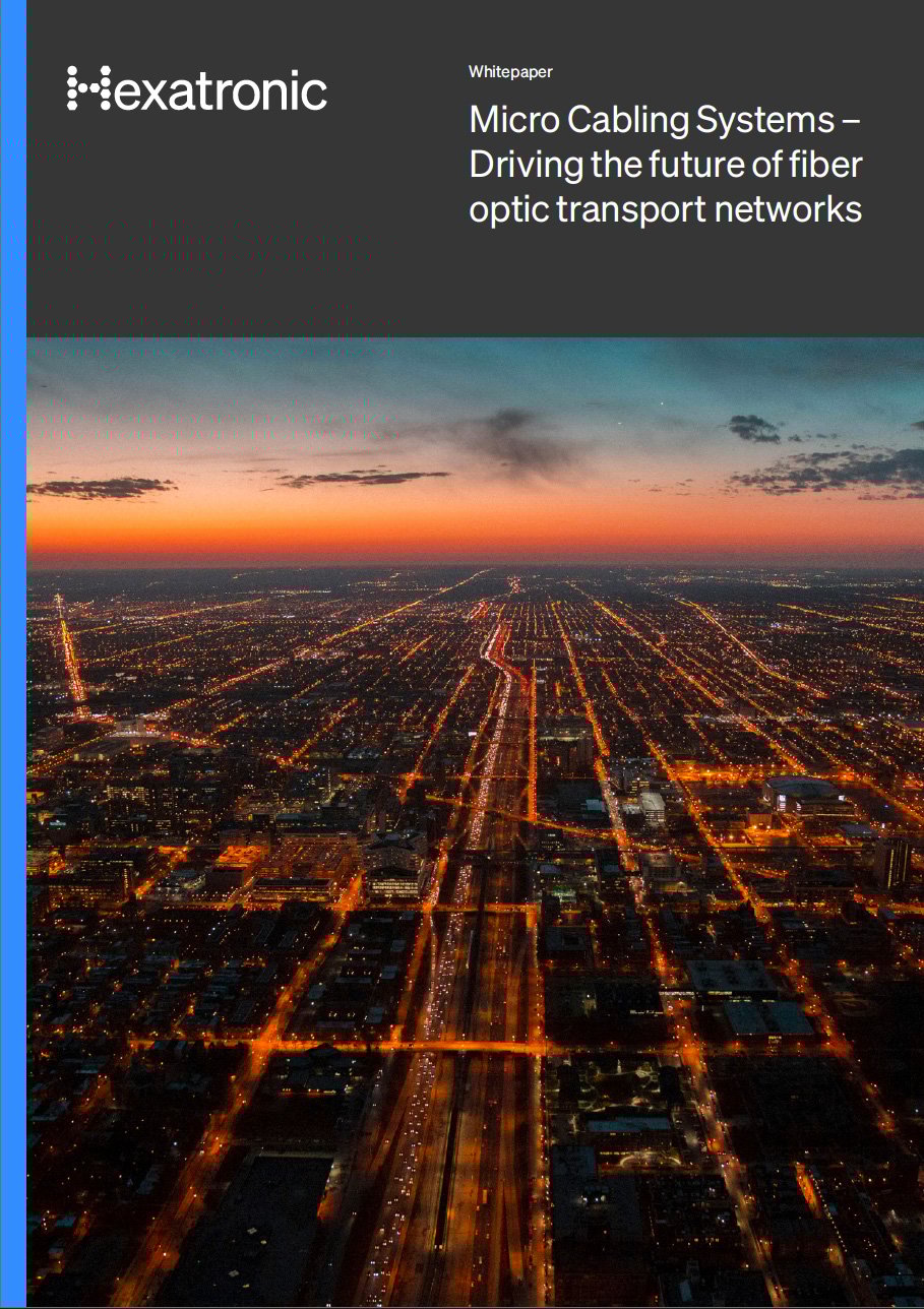 A cover of a Hexatronic whitepaper about micro cabling in transport networks, showing an aerial view of a city at dawn.
