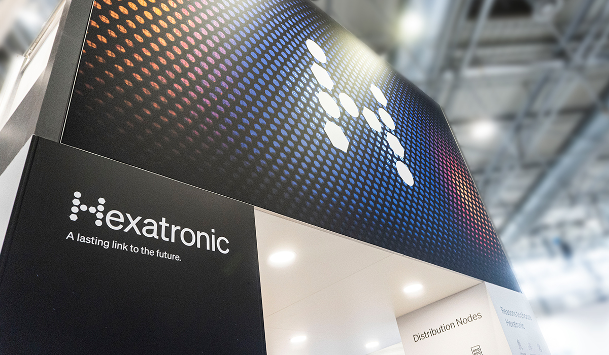 Hexatronic stand at a conference, showing a sign of the H symbol and the Hexatronic logo with the text A lasting link to the future under.