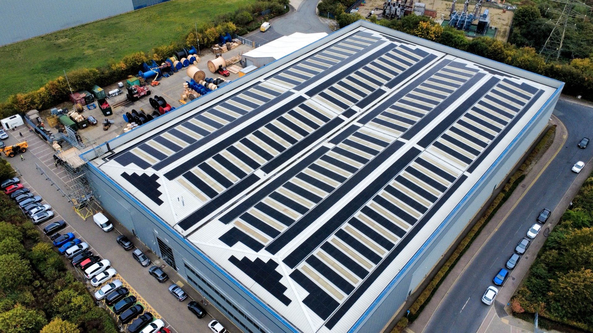 Aerial view of the Fibron Cable facility in the UK. The roof is covered in solar panels.