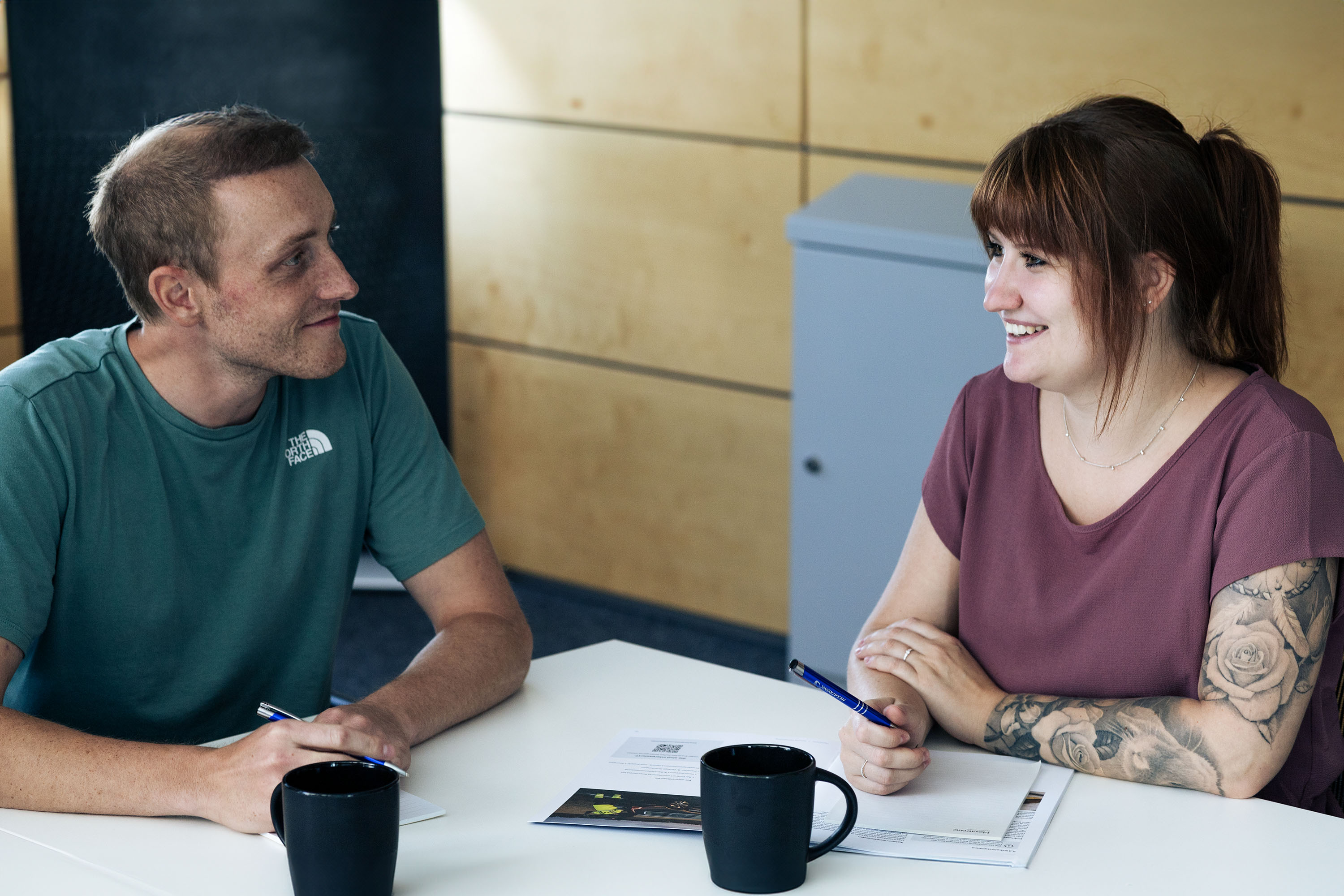 Discussion between two colleagues in the office.