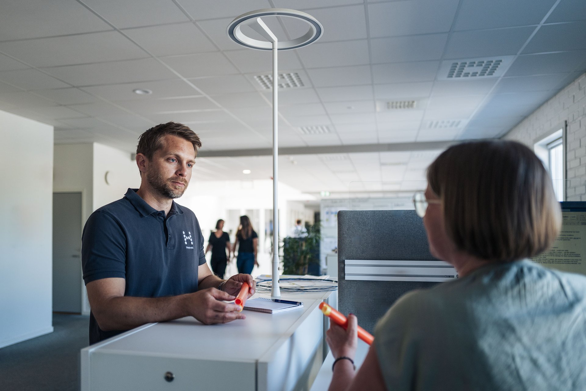 Two people talking in an office environment.