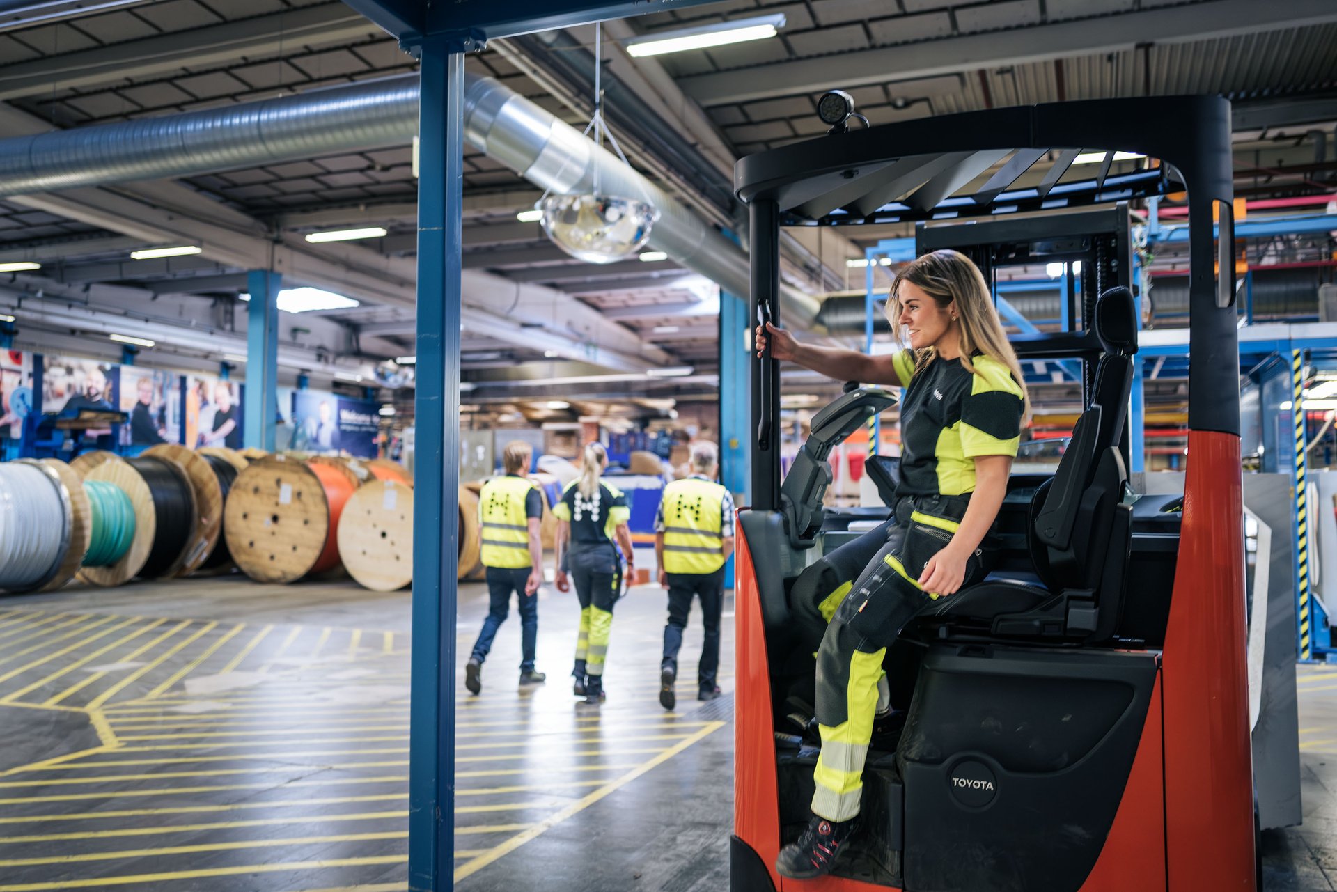 Woman sitting on a truck inside of the Hexatronic factory.