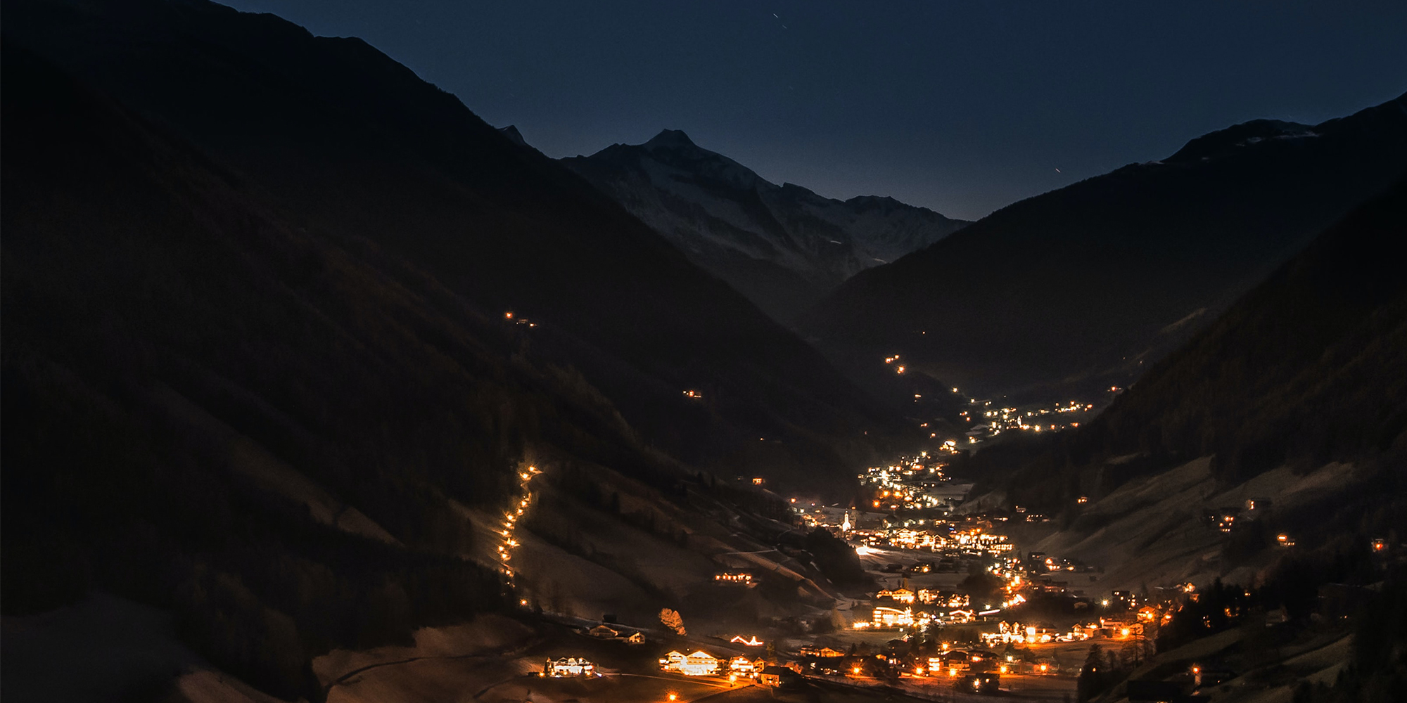 Bright-village-in-valley-dark-evening
